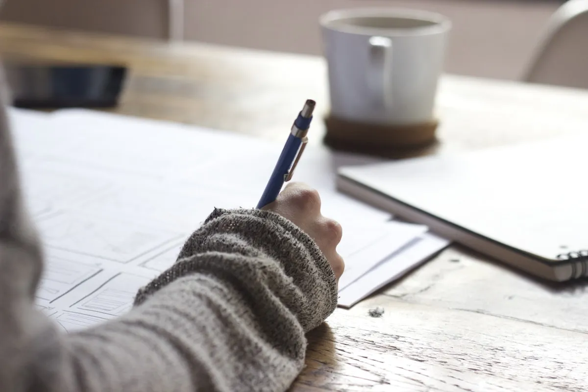 A clean desk with coffee and a journal ready for a productive morning