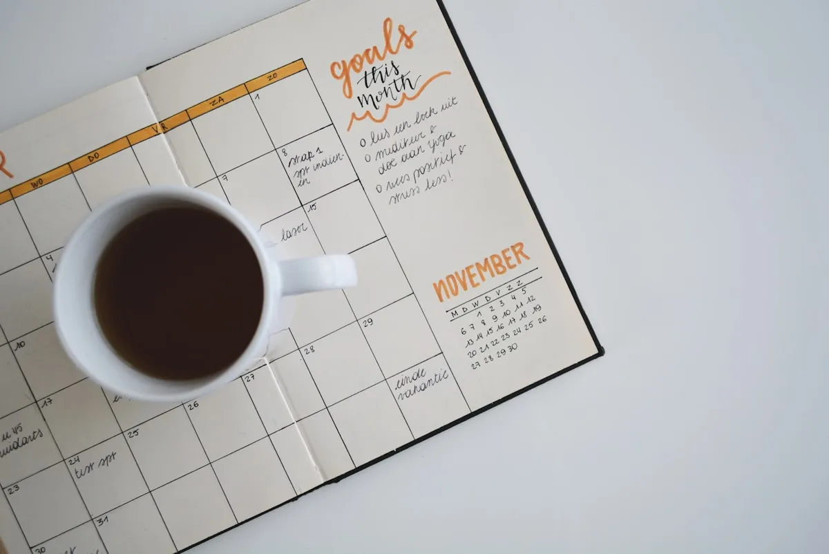 Calendar and planner laid out on a desk for tracking daily habits